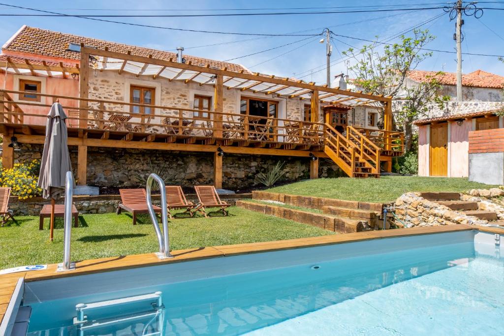 a villa with a swimming pool and a house at Terra Lodge in Ericeira