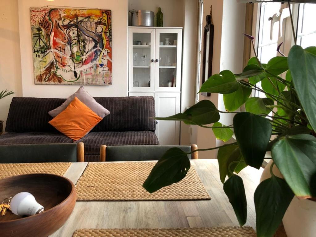ein Wohnzimmer mit einem Tisch und einer Pflanze in der Unterkunft Beautiful Apartment With Terrace Near Kentish Town in London