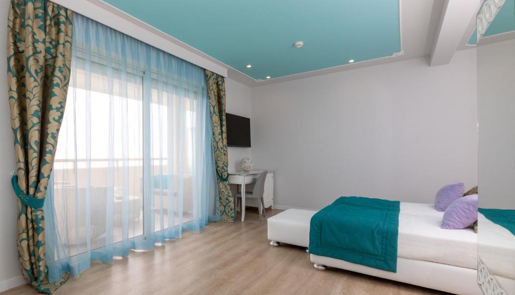 Postel nebo postele na pokoji v ubytování Hotel Carlton