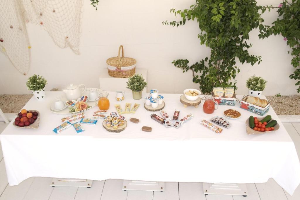 a white table with food on it at Hotel San Giovanni in Polignano a Mare