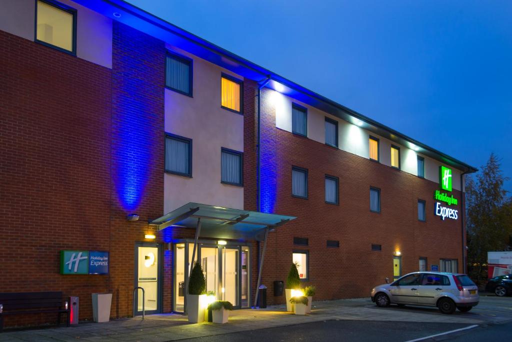 a building with a car parked in front of it at Holiday Inn Express Bedford, an IHG Hotel in Bedford