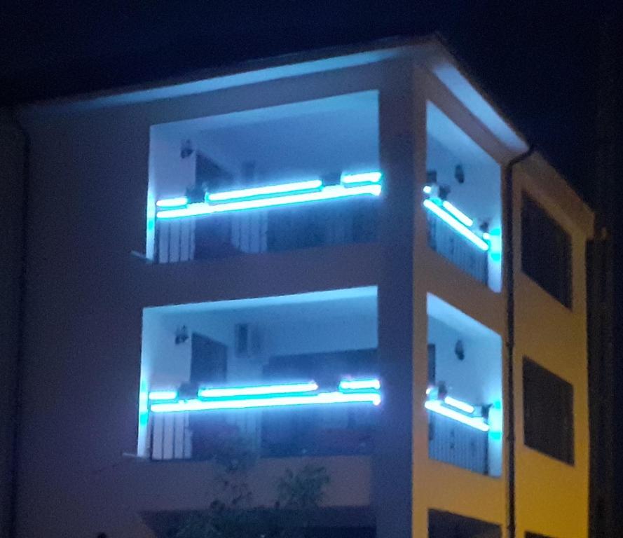 a building with blue lights on the side of it at Splendid Aparthotel in Năvodari