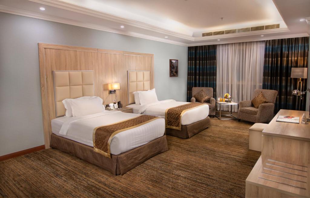 Postel nebo postele na pokoji v ubytování Iridium 70 Hotel