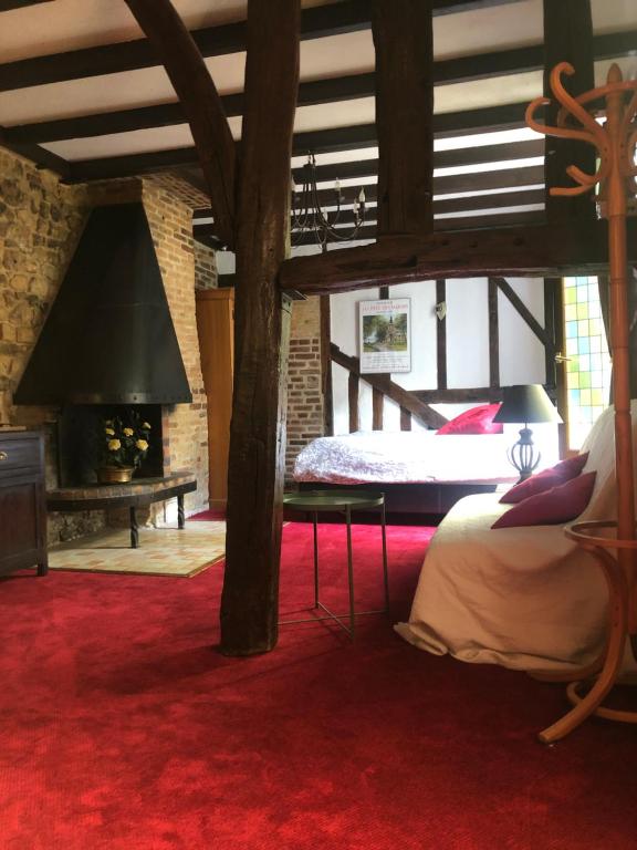 a bedroom with a large bed and a fireplace at Tim's secret place in Honfleur