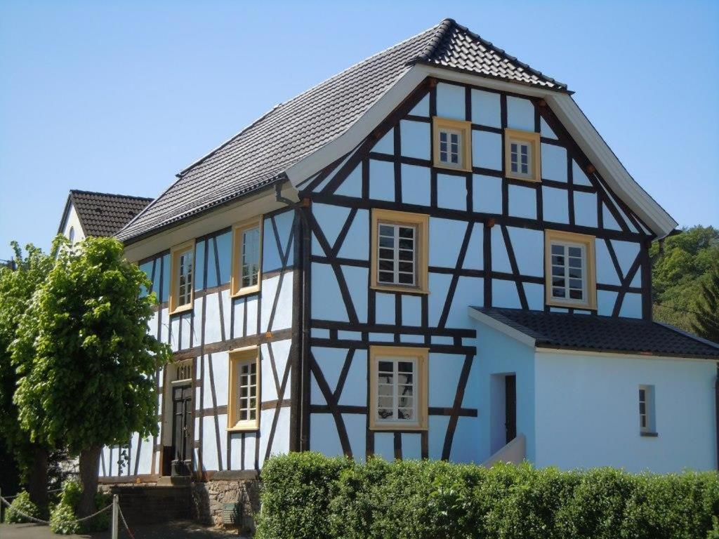 a house with a black and white building at Anno 1772 in Dattenfeld