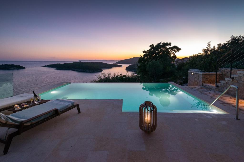 a swimming pool with a lamp and a view of the ocean at Sivota's Secret Villa in Sivota