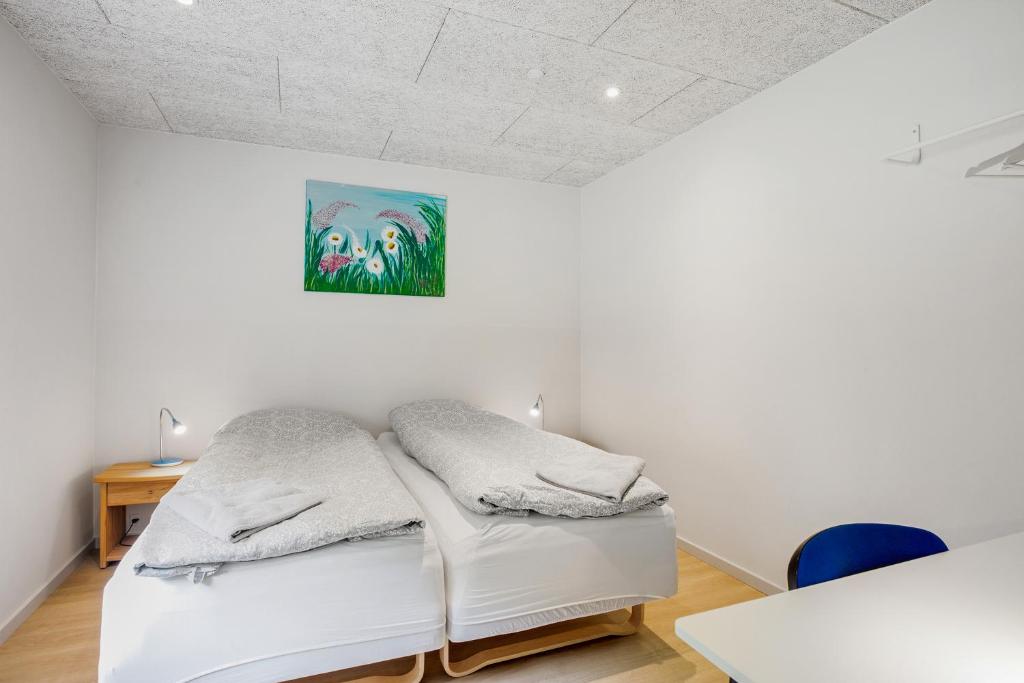 Una cama blanca en una habitación con un cuadro en la pared en Gørding Bed and Breakfast, en Gørding