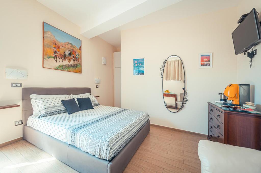 a bedroom with a bed and a flat screen tv at B&B Floridia in Taormina