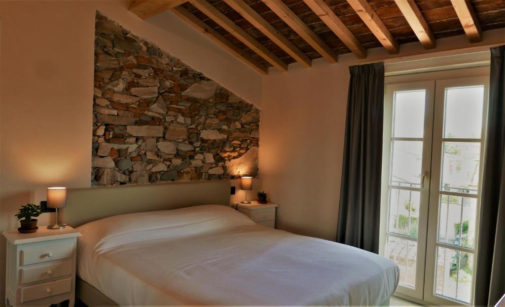 Postel nebo postele na pokoji v ubytování Il Tiglio Jacuzzi&Sauna