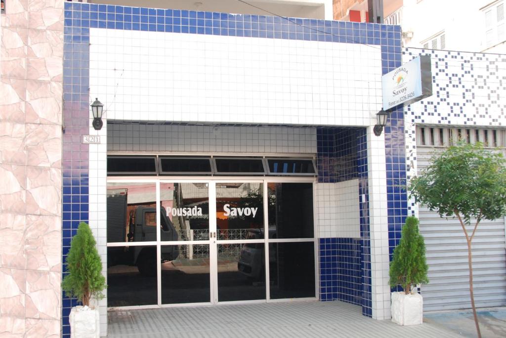 a store front with blue tiles on the facade at Pousada Savoy in Fortaleza