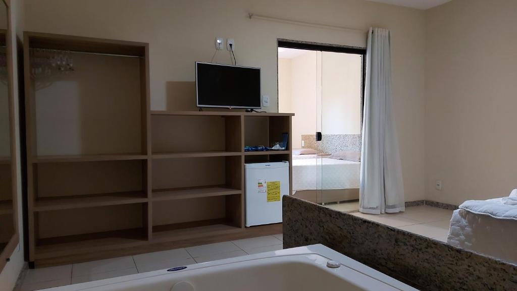 TV a/nebo společenská místnost v ubytování Porto Bali Hotel