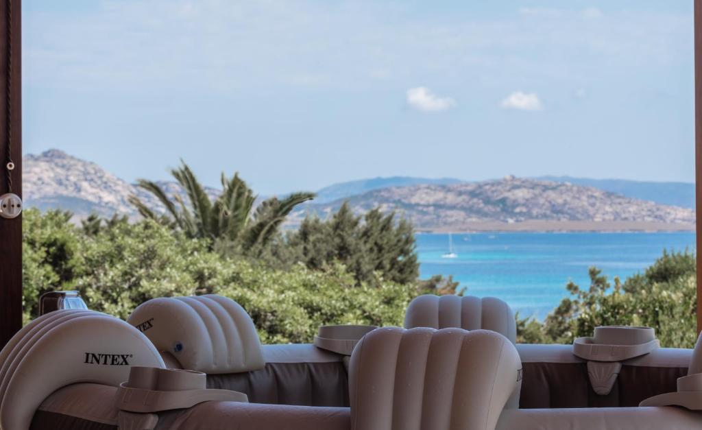 a view of the ocean from the balcony of a house at Villa Boat - in front of the Sea in Stintino