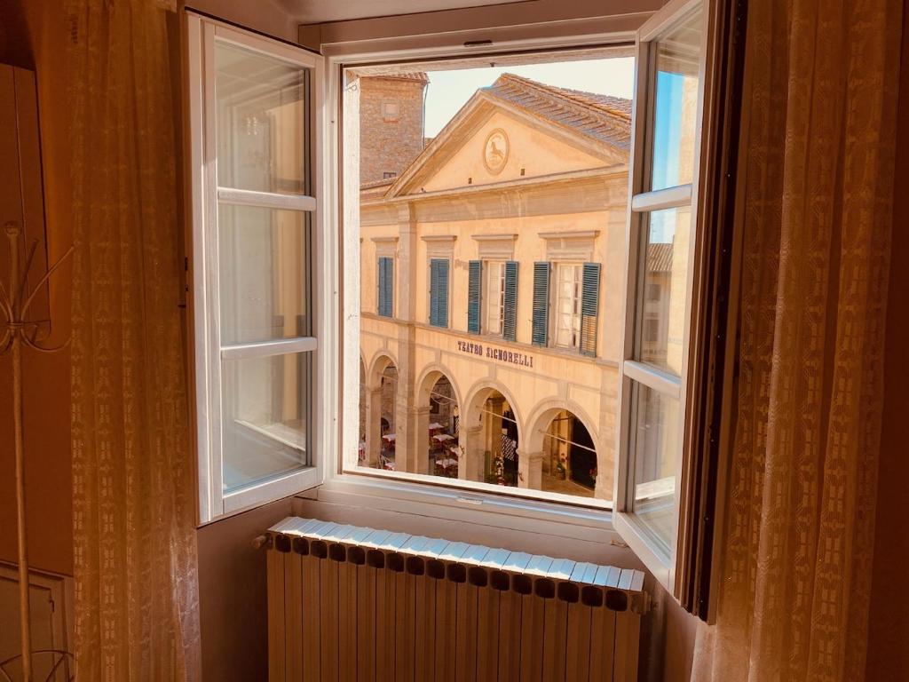 an open window with a view of a building at Casa Teatro in Cortona