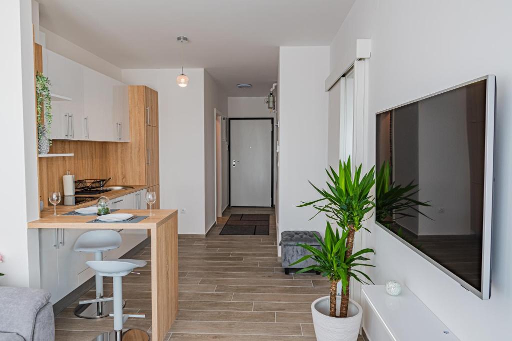 a kitchen and living room with a table and a counter at Jacuzzi - Flexible SelfCheckIns 20 - Zagreb - Luxury - Garage - Smart - Brand New - Apartments Repinc in Zagreb