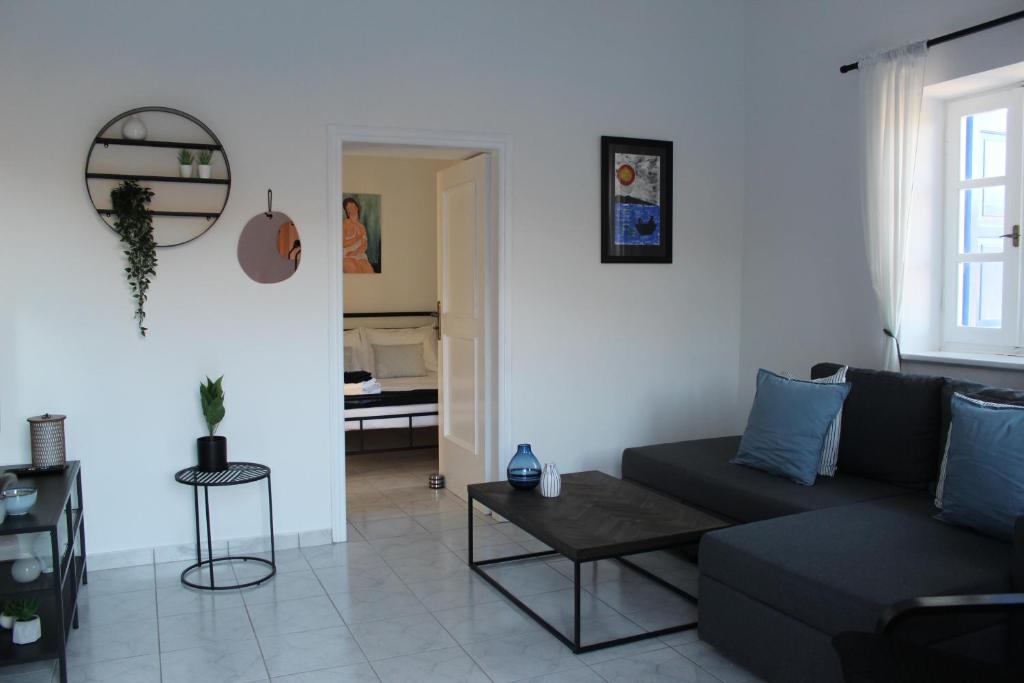 a living room with a couch and a table at Cycladic Villa in Amorgos Island (Maison Shiro) in Arkesíni