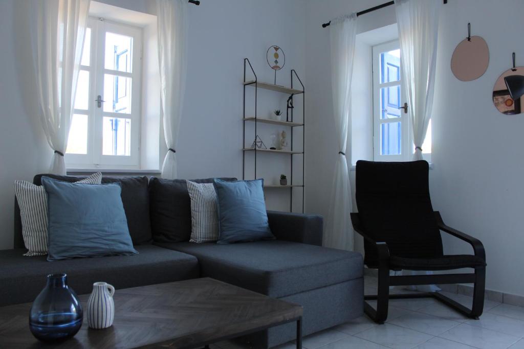 a living room with a couch and a chair at Cycladic Villa in Amorgos Island (Maison Shiro) in Arkesíni