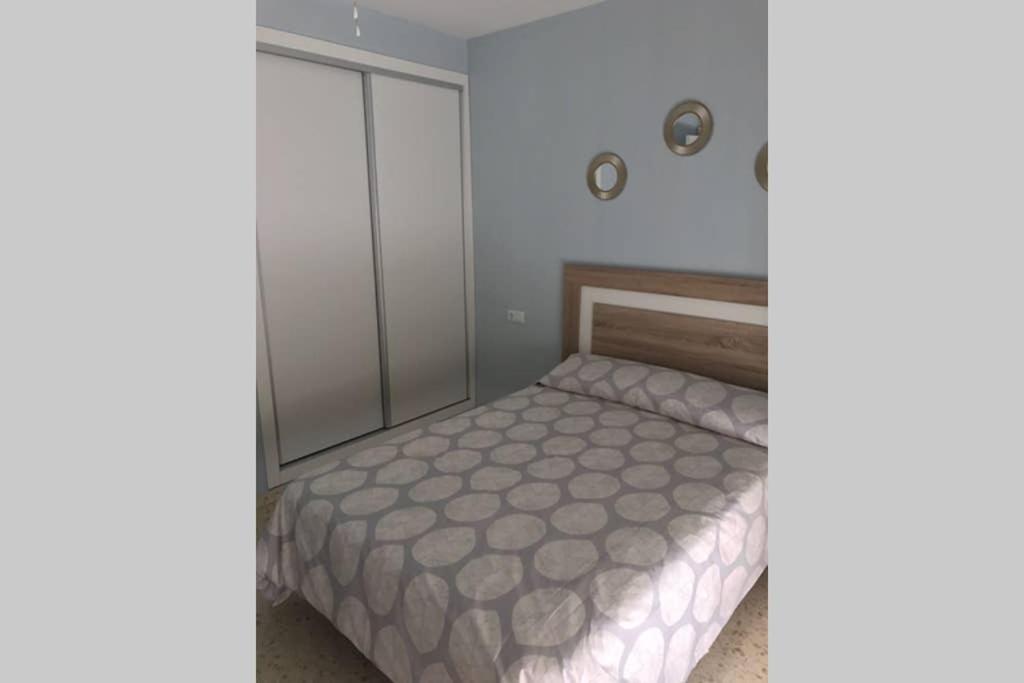 a small bedroom with a bed and a closet at CASA MARINA DE LA BAHIA in Puerto Real