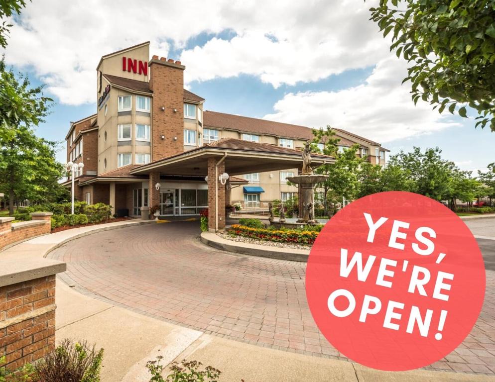 a sign that says yes were open in front of a hotel at Monte Carlo Inn Brampton in Brampton