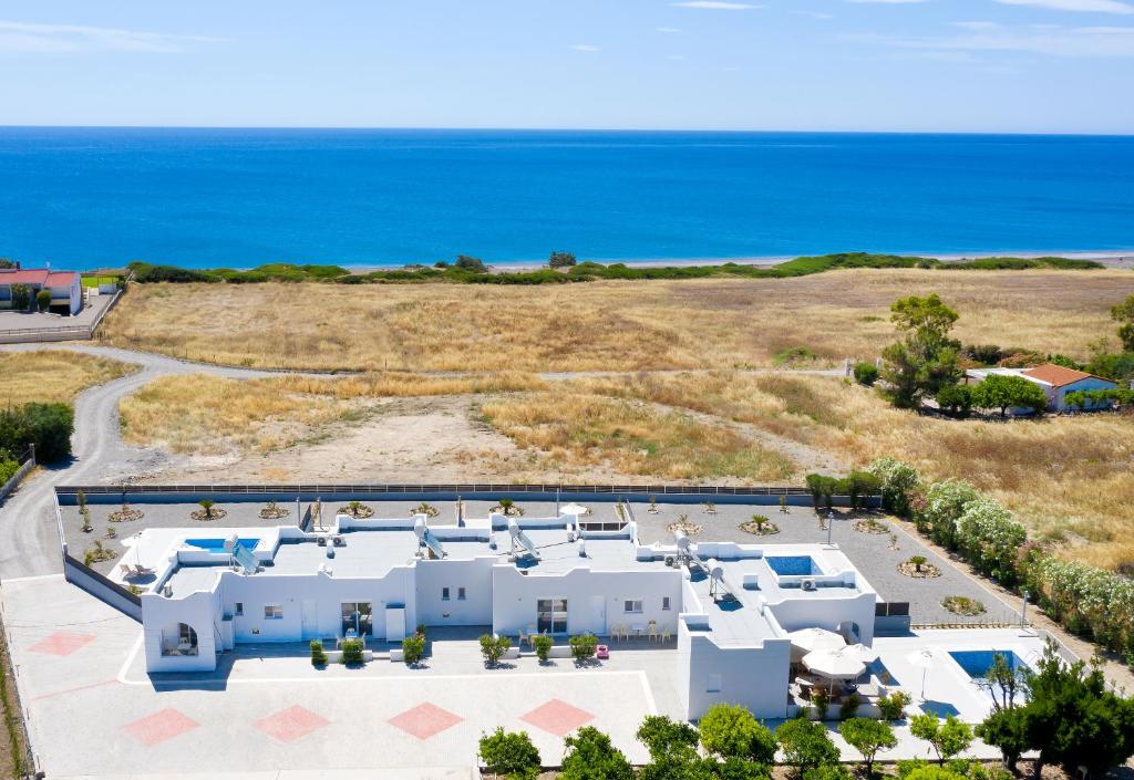 an aerial view of a villa with the ocean in the background at Aegean Horizon apartments in Gennadi