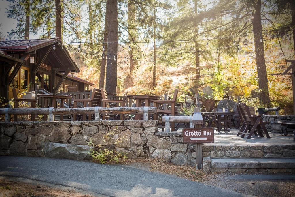a group of tables and chairs in a forest at Sleeping Lady Mountain Resort in Leavenworth