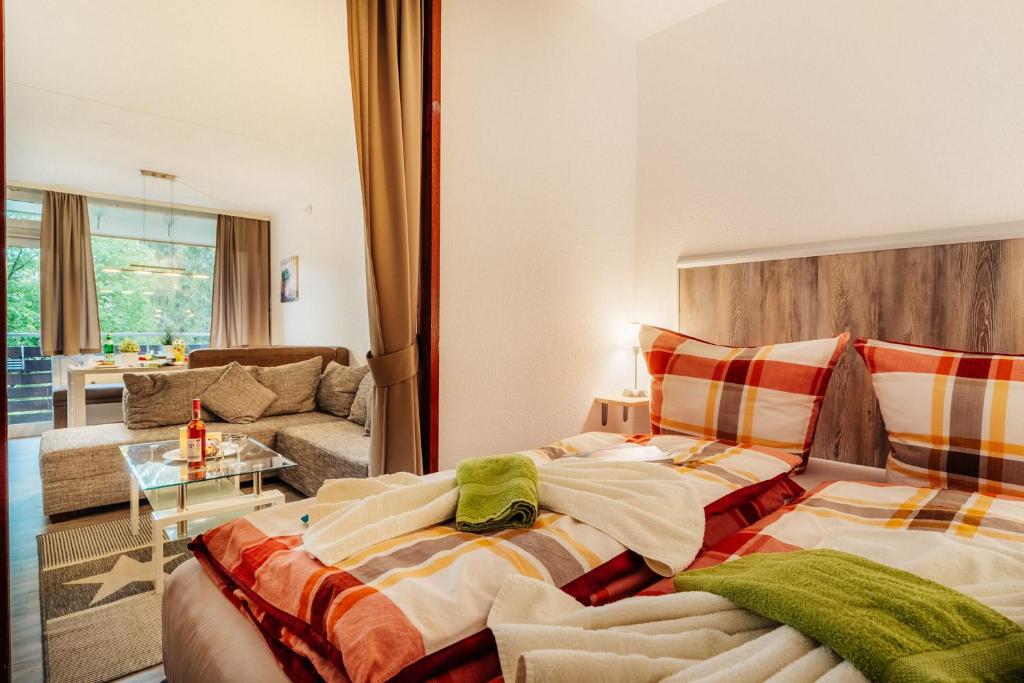 a bedroom with two beds and a living room at Hexe III in Altenau