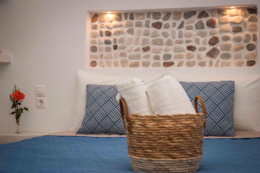 a wicker basket sitting on top of a bed at PERIVOLI 4-CHORA(5min away from the center by car) in Agkidia