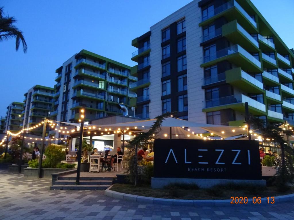 a hotel with a sign in front of a building at Yasuo Beach Apartment in Mamaia Sat/Năvodari