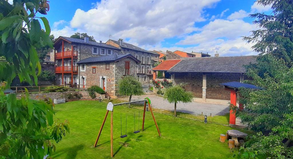 un patio con parque infantil frente a un edificio en Cal Francès en All