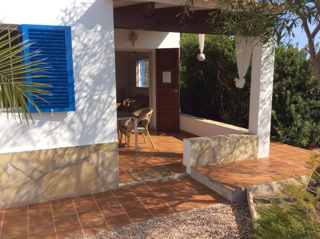 a house with a porch and a patio at VIVIENDAS ES CARNATGE in Playa Migjorn
