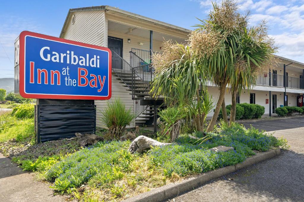 a sign for a car rental inn of the day at Garibaldi Inn at the Bay in Garibaldi