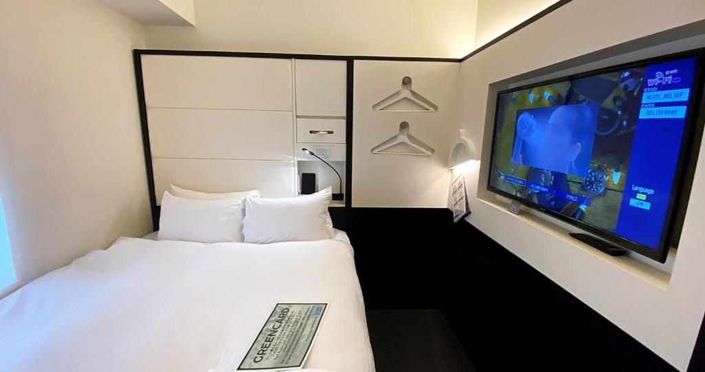 Postel nebo postele na pokoji v ubytování HOTEL SUI KANDA by ABEST