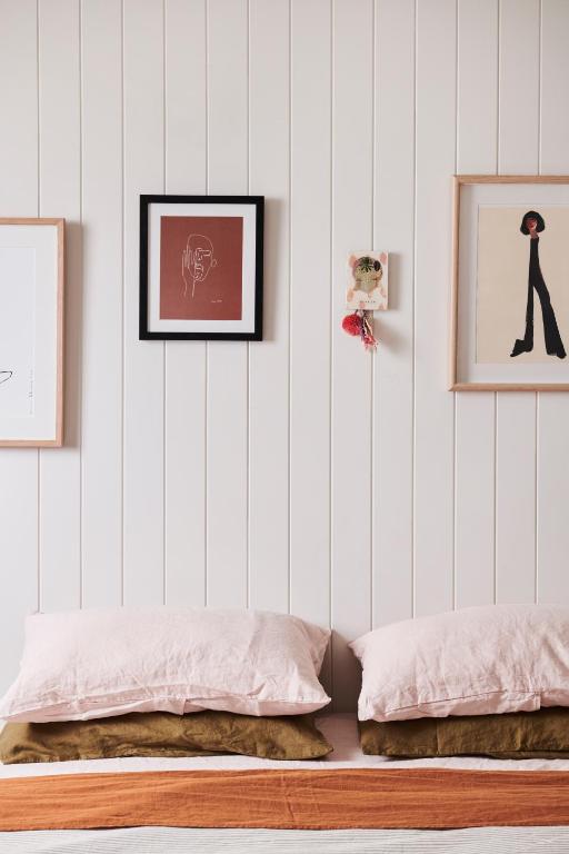 a bedroom with two beds and two pictures on the wall at Anchor Geelong in Geelong