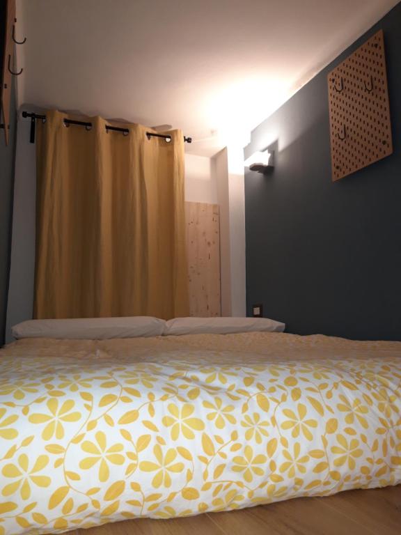 um quarto com uma cama com um cobertor amarelo em Metro Station Mini Van CAPSULA House em Turim
