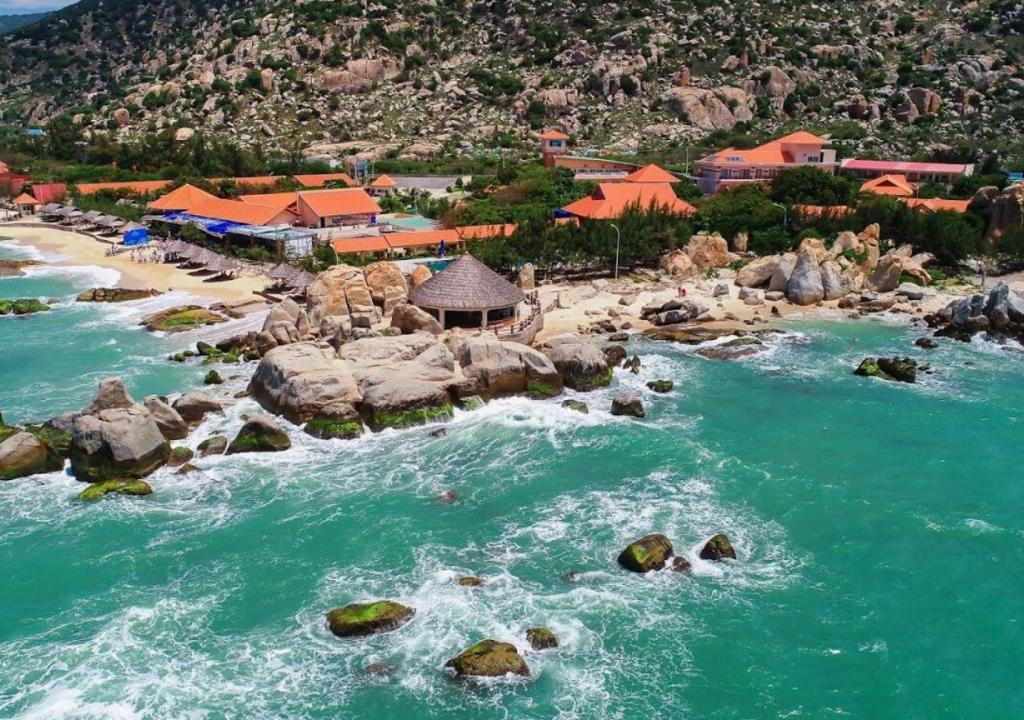 an aerial view of a beach with rocks in the water at Hòn Cò Resort - Cà Ná in Thôn Lạc Nghiệp