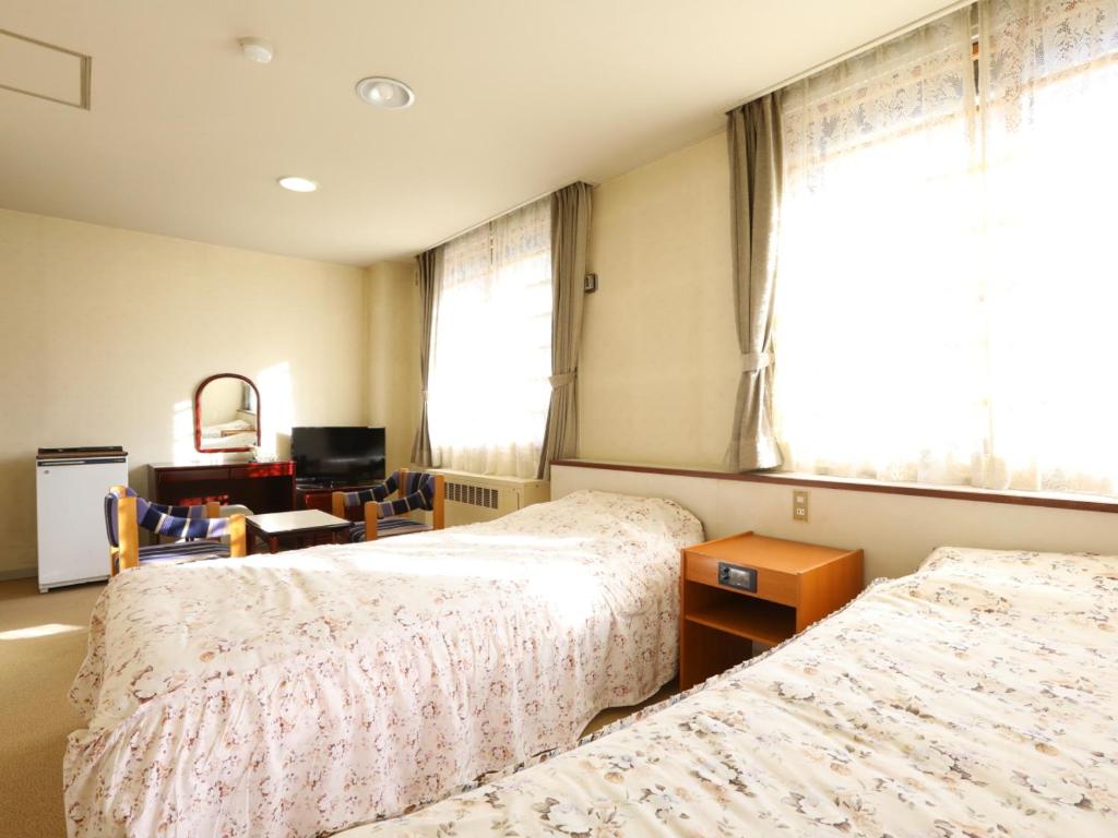 Postel nebo postele na pokoji v ubytování Hotel Ichibokaku