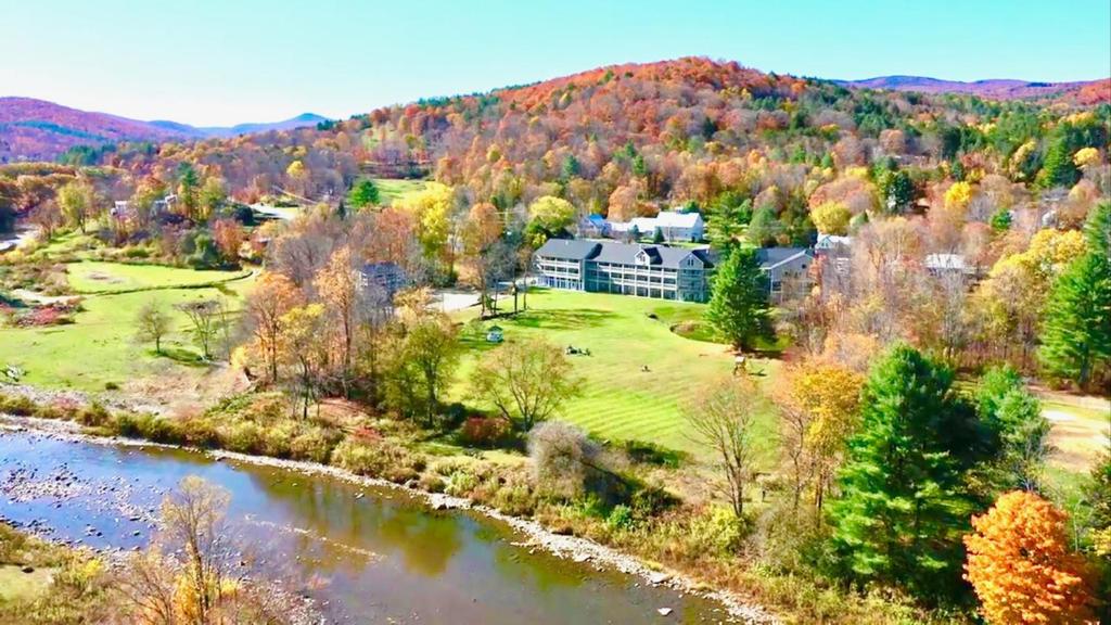 an aerial view of a house in the mountains with a river at 506 On the River Inn Woodstock in Woodstock