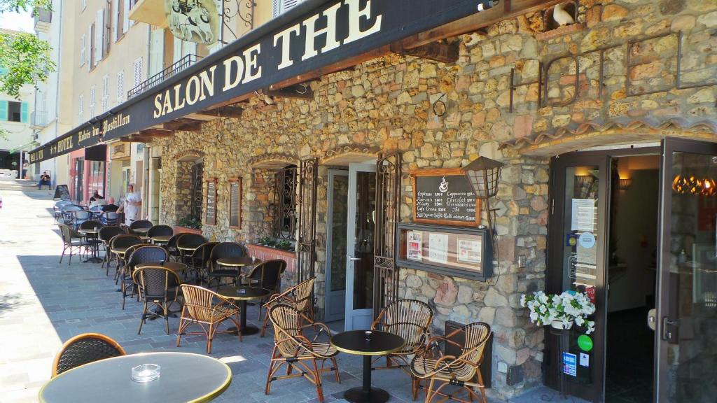 a row of tables and chairs outside of a building at Hotel Relais Du Postillon in Antibes