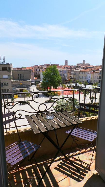 a view of a balcony with a table and chairs at Hotel Relais Du Postillon in Antibes