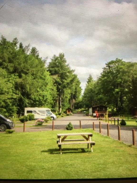 a picnic table in the grass in a park at Chalet 2 in Tyndrum