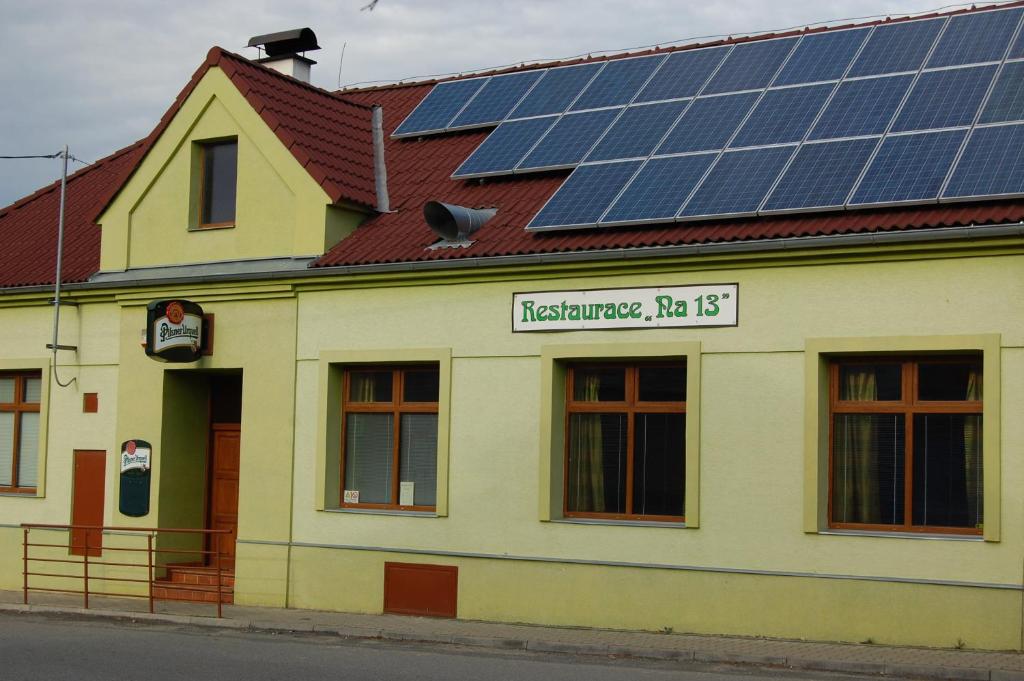 a building with solar panels on the roof at Penzion na 13 Lipník in Lipník