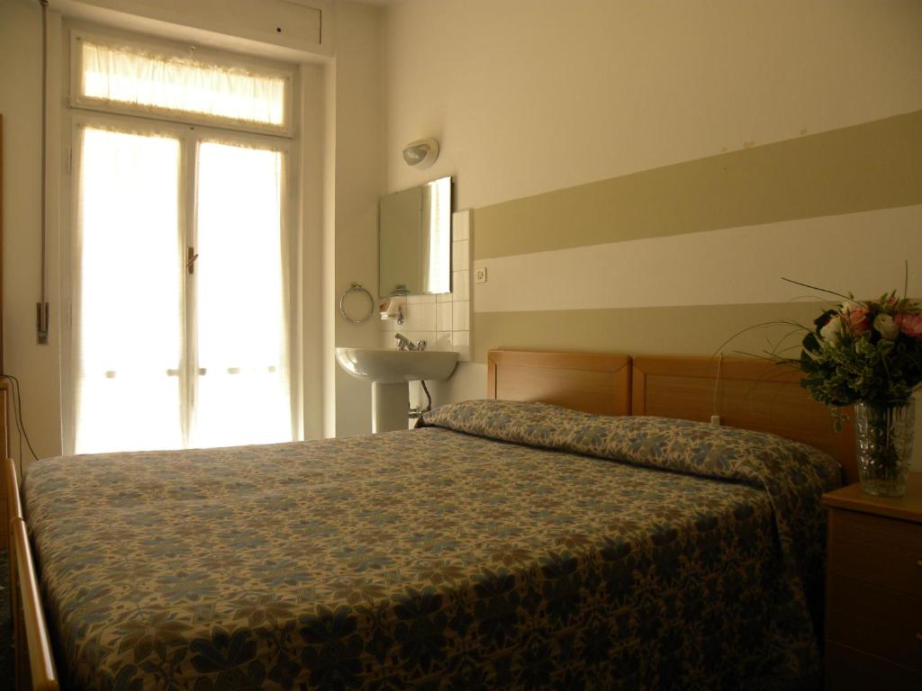 Postel nebo postele na pokoji v ubytování Albergo La Neigra