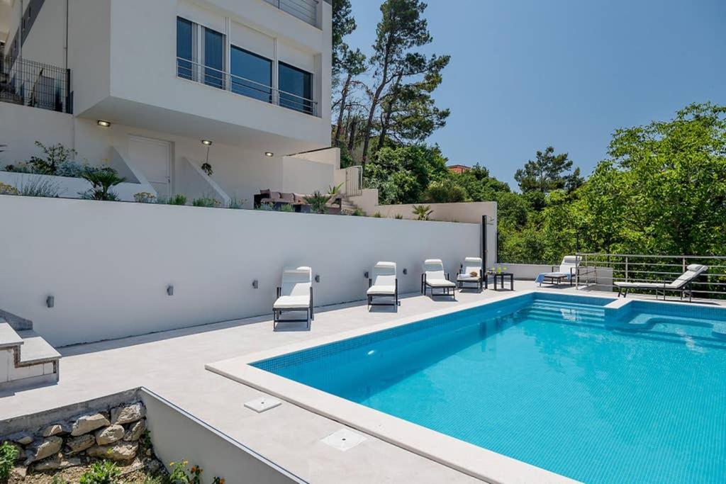 a swimming pool in the backyard of a house at Villa Graf in Podstrana