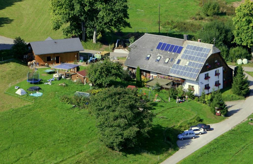 an aerial view of a house with solar panels on it at Ferienhof Gerda in Sankt Georgen im Schwarzwald
