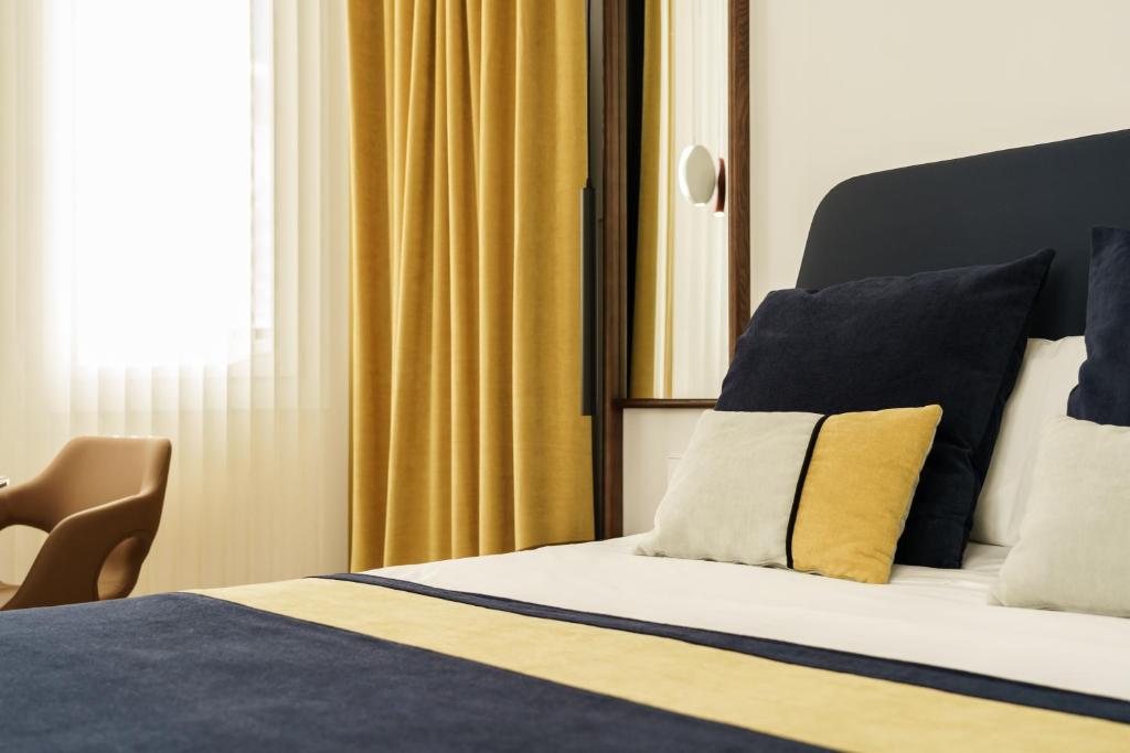 Postel nebo postele na pokoji v ubytování Smartrental Collection Gran Vía Centric