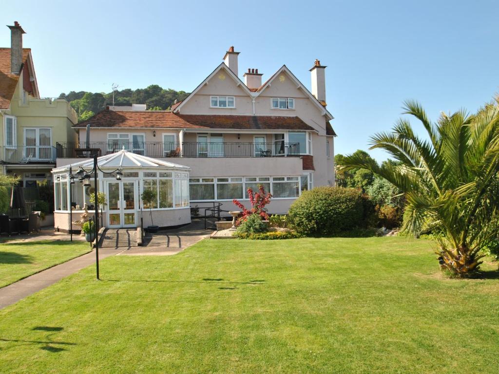 a large house with a gazebo in the yard at Beachside Suites in Minehead
