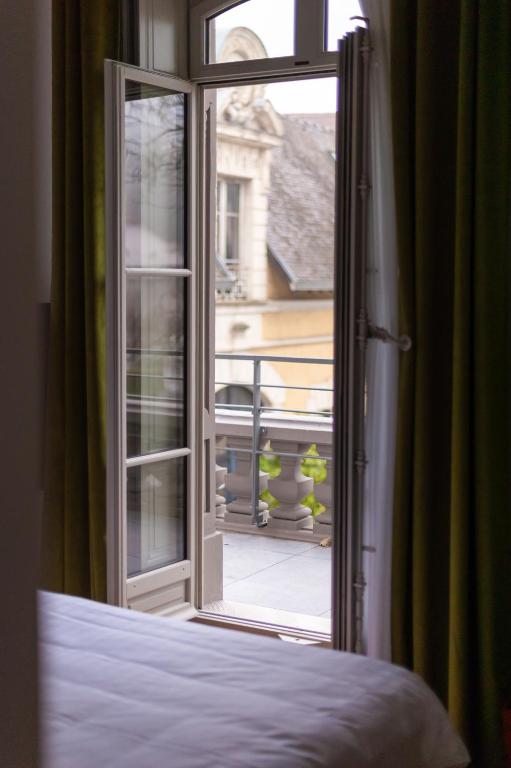 Postel nebo postele na pokoji v ubytování Hôtel Mille Pas