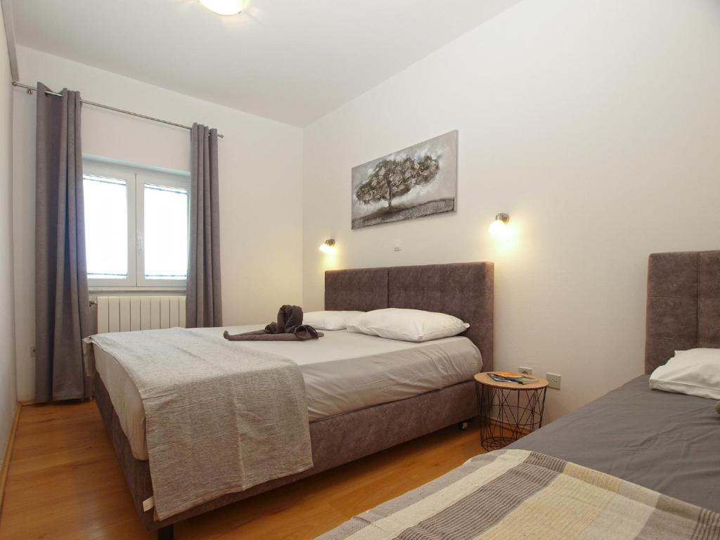 Postel nebo postele na pokoji v ubytování Apartments Biskupije 810