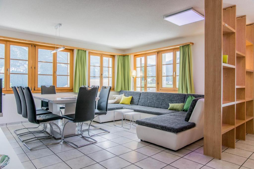 - un salon avec un canapé et une table dans l'établissement Apartment Dolomit EG - GRIWA RENT AG, à Grindelwald