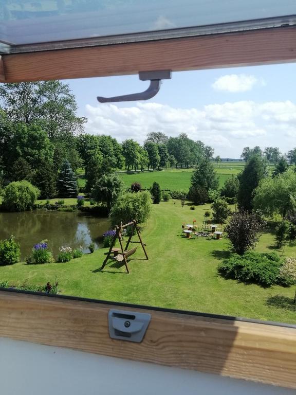 a view from a window of a garden at Agroturystyka nad stawem Mazuchówka in Wydminy