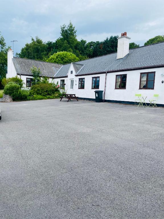 a white building with a picnic table in front of it at Spring & Haven in Conwy